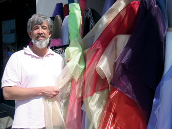 Party planner Roy Braeger ’86 with some of the colorful fabrics he uses in designing an event setting. PHOTO: JON COURIE